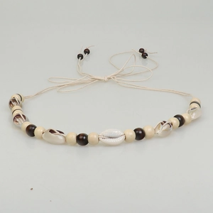 Detail of bohemian handmade braided rope accessory with natural shells and wooden beads