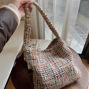 Colorful handmade knit shoulder bag with tweed texture and vibrant wool weave design