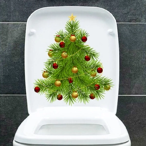 Detailed view of a green Christmas tree sticker with red balls on a white toilet cover