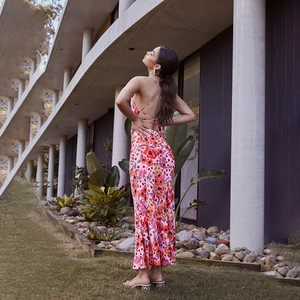 Detail of the backless floral maxi dress featuring elegant crisscross tie straps