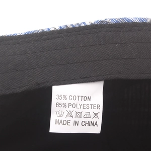 British plaid beret label detail showing 35% cotton and 65% polyester material composition