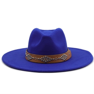 Detail of bright blue wool fedora with brown studded leather band and silver studs