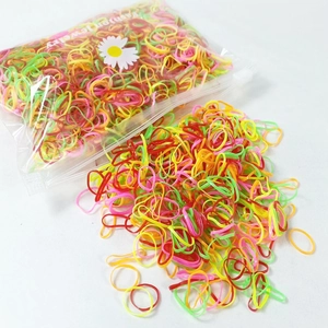 Detailed macro view of colorful elastic hair ties in transparent storage bag