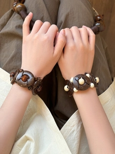 Detail of bohemian coconut shell beaded bracelets featuring handmade ethnic weave pattern