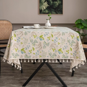 Detail of fringe tassels on vintage blue floral pattern linen blend tablecloth