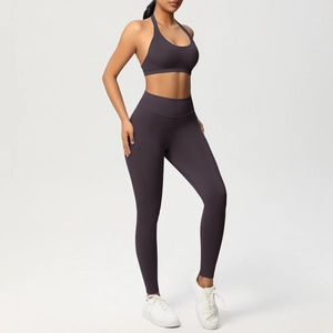 Dettaglio del set da yoga viola scuro con reggiseno a vogatore e leggings a vita alta