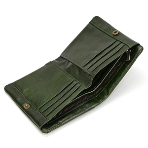 Detail of dark green leather wallet showing interior card slots and zipper pocket