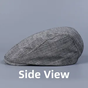 Side profile of a classic herringbone flat cap in grey wool blend fabric