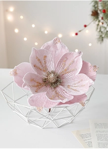 Pink velvet artificial flower with gold glitter details in a white metal basket