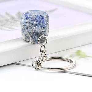 Close-up of a natural blue lapis lazuli raw stone keychain with silver metal ring