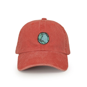 Close-up of earth embroidery on washed cotton baseball cap in terracotta red