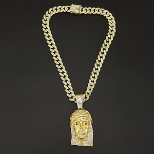 Detailed view of a gold-plated iced-out Jesus piece pendant on a heavy Cuban link chain