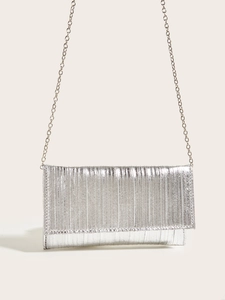 Detail view of silver evening clutch bag with elegant pleated texture and metal chain strap