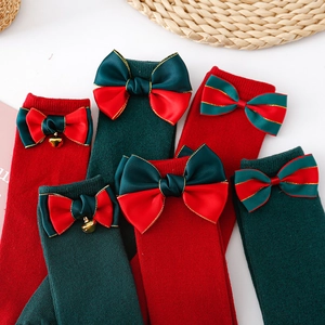 Christmas children's knee high socks with large bows and bells in red and green