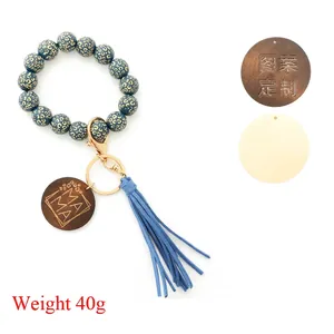 Leopard print beaded wristlet keychain with MAMA wood tag and tassel on white background