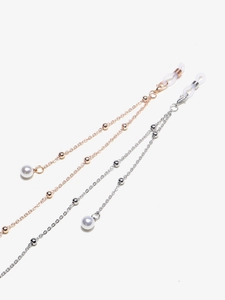 Detail of gold and silver metal eyeglass chains with white pearls and anti-slip silicone loops