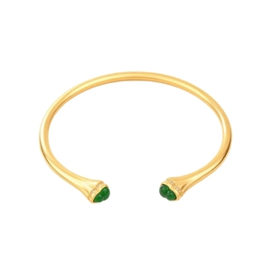Vintage gold open bangle with green gemstones and white crystals on white background