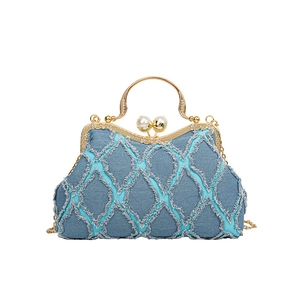 Blue denim shell-shaped handbag with golden frame, pearl clasp, and chain shoulder strap