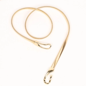 Detail of gold metal spring belt showing snake chain texture and hook fastener clasp