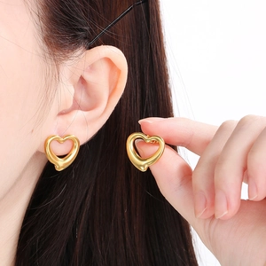 Detailed view of gold hollow heart earrings showing polished finish and delicate design
