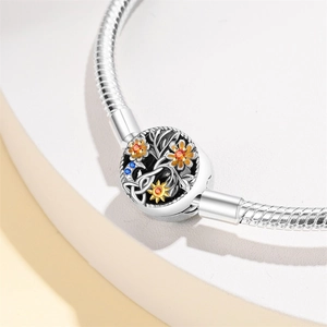 Detailed close-up of a silver Tree of Life charm with colorful flowers on a snake chain