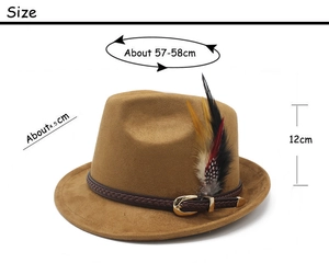 Detail of brown fedora hat featuring a woven leather band with feathers and metal buckle