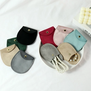Multi-color velvet jewelry pouches with gold snap buttons and pearl necklace details