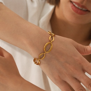Detail of 18K gold plated stainless steel bracelet with large oval link chain on wrist