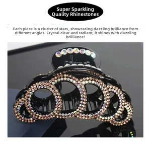 Detailed view of large black hair claw clip with champagne rhinestone ring patterns