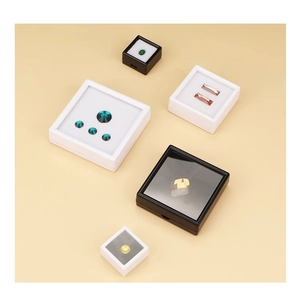 Detailed top view of square acrylic gemstone display boxes with black and white foam inserts
