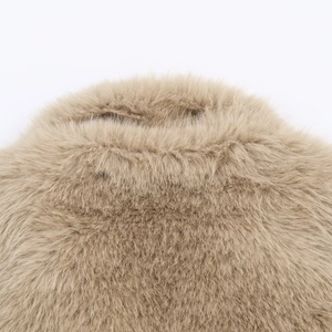 Detailed macro view of soft khaki faux fur texture and fluffy synthetic fibers