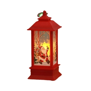Detail of red Christmas LED lantern with Santa Claus illustration and warm flame light