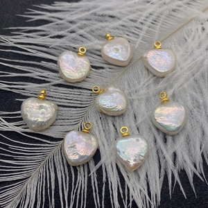 Natural freshwater pearl irregular heart pendants with gold loops on white feathers