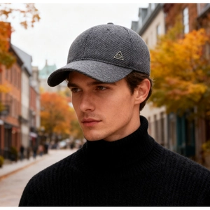 Detail of grey winter baseball cap with ProHike metal badge and thick wool-like texture