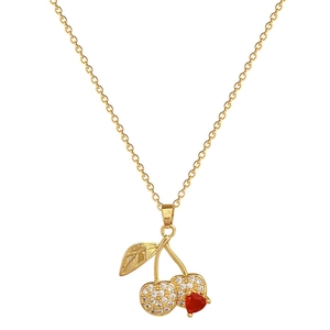 Luxury gold cherry necklace with red heart stone and sparkling crystals on white background