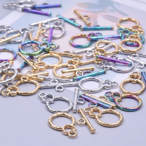 Macro shot of stainless steel OT toggles in gold, silver, and rainbow for DIY necklaces