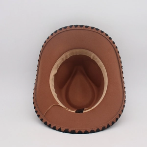 Detail view of the brown wool fedora featuring unique black wavy edge stitching and sweatband