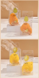 Detail view of pear and lemon shaped makeup sponges in transparent branded packaging