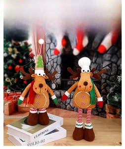 Close-up of reindeer plush dolls with Christmas scarves and gingerbread button details