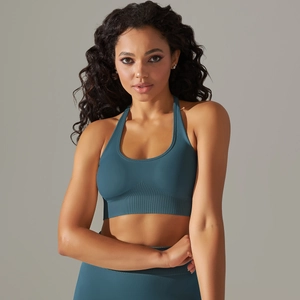 Detailed view of seamless knit yoga bra with halter neck design in deep teal blue