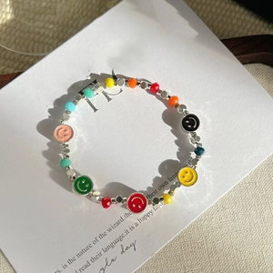 Close-up of colorful smiling face beaded bracelet with silver metal accent beads
