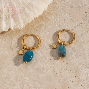 Detail of gold star pendant and blue natural stone on gold plated stainless steel earring
