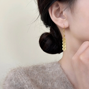 Elegant Chinese style golden coin tassel earrings on model with high quality metal finish