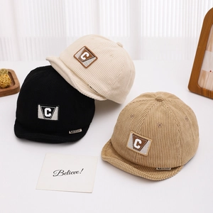 Three corduroy baby caps in black, cream and khaki with letter C patch detail