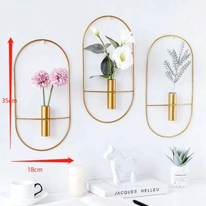 Detailed view of 35cm gold geometric metal wall vases with cylindrical flower holders
