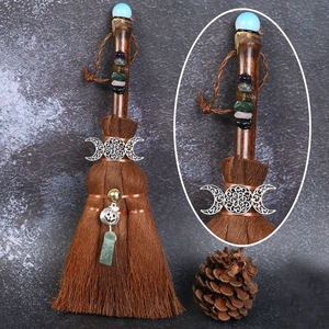 Detailed view of handmade witch broom pendant featuring colorful natural crystal stones