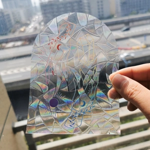 Close-up of arched holographic suncatcher sticker featuring palm and moon patterns