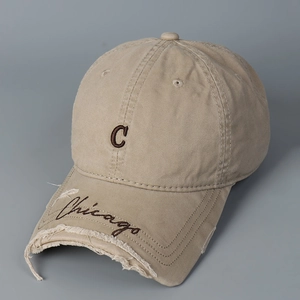 Close-up of leopard 'C' embroidery and distressed details on a khaki baseball cap