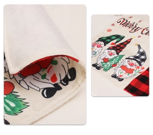 Close-up of linen Christmas placemat showing woven texture and festive gnome patterns