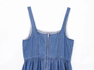 Dettaglio dell'abito in denim blu con scollo quadrato, spalline e cerniera in metallo